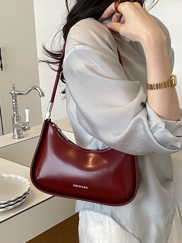 Nicho de diseño bolso de brazo para mujeres 2026 comercio exterior nueva moda alta sensación de viaje simple bolso de media luna de hombro