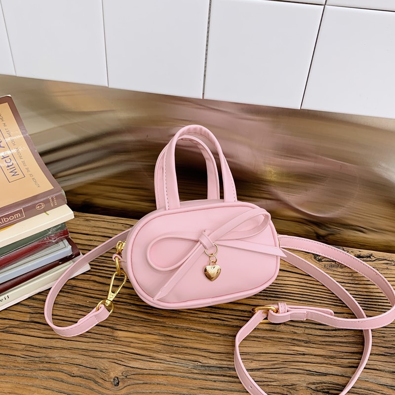 Coreano simple color sólido bolso de hombro para niños y niñas mini bolso de bebé lindo dulce bolso de arco para niños
