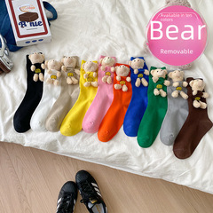 Trendy socks featuring adorable 3D teddy bear doll accents—stylish solid-color pile-up socks in the Dongdaemun Korean-style aesthetic.