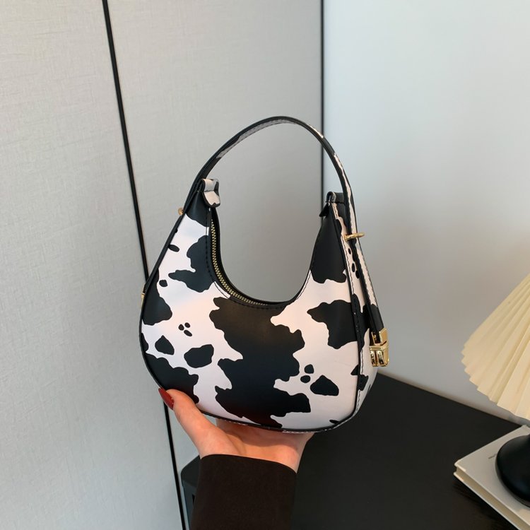 Exquisita moda con estampado de leopardo 2024 nuevo estilo estilo occidental patrón de cebra personalidad textura tendencia mensajero portátil bolso de luna nueva mujer