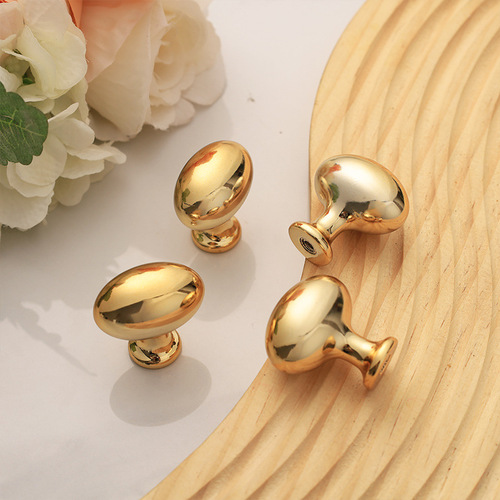 Gold French-style bedside cabinet with elliptical drawer pulls, electroplated plastic single hole handles, pigeon egg design