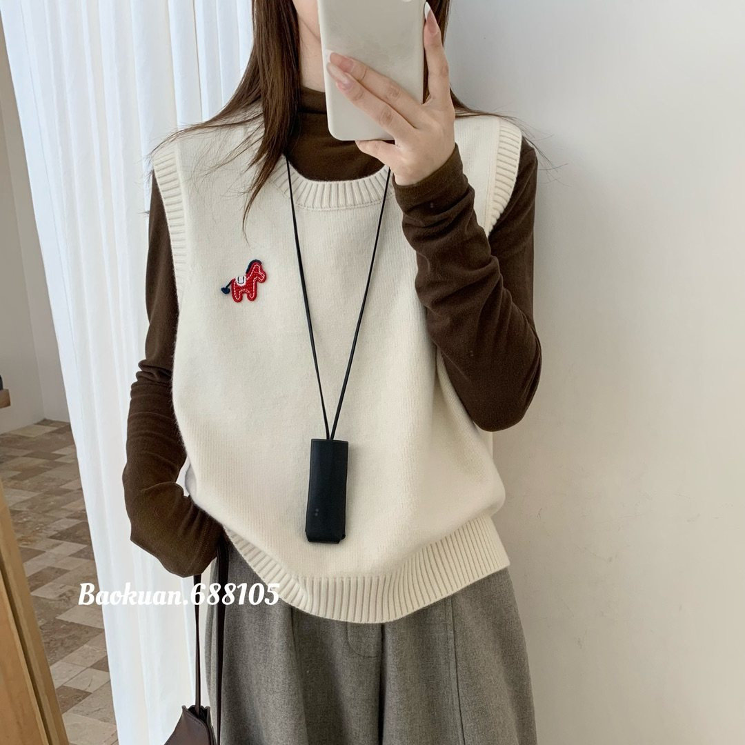 Knitted autumn demi-season vest with a round collar
