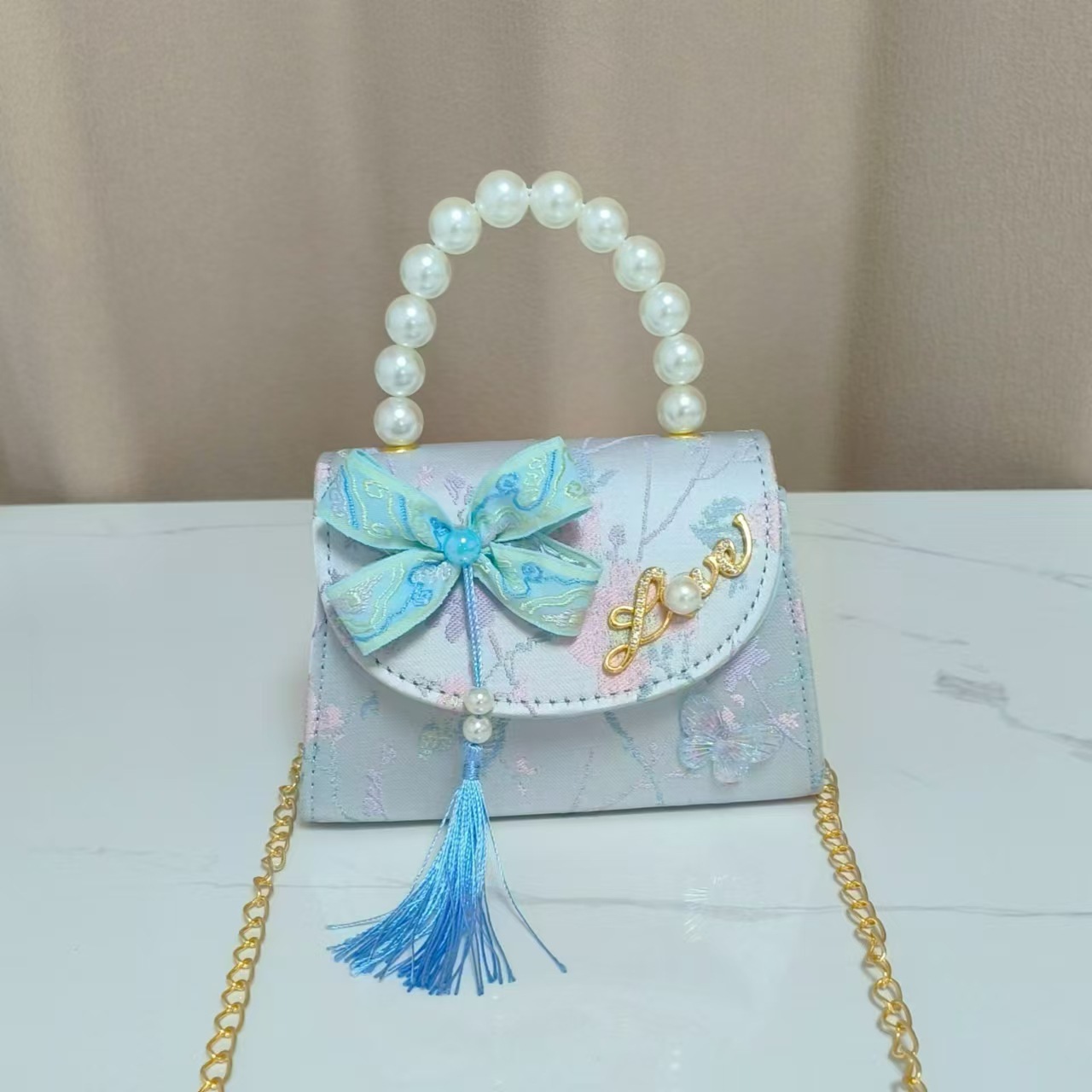 Bolsas de niños arco de estilo chino borda de niña pequeña princesa perla bolsa de cambio de mano al por mayor