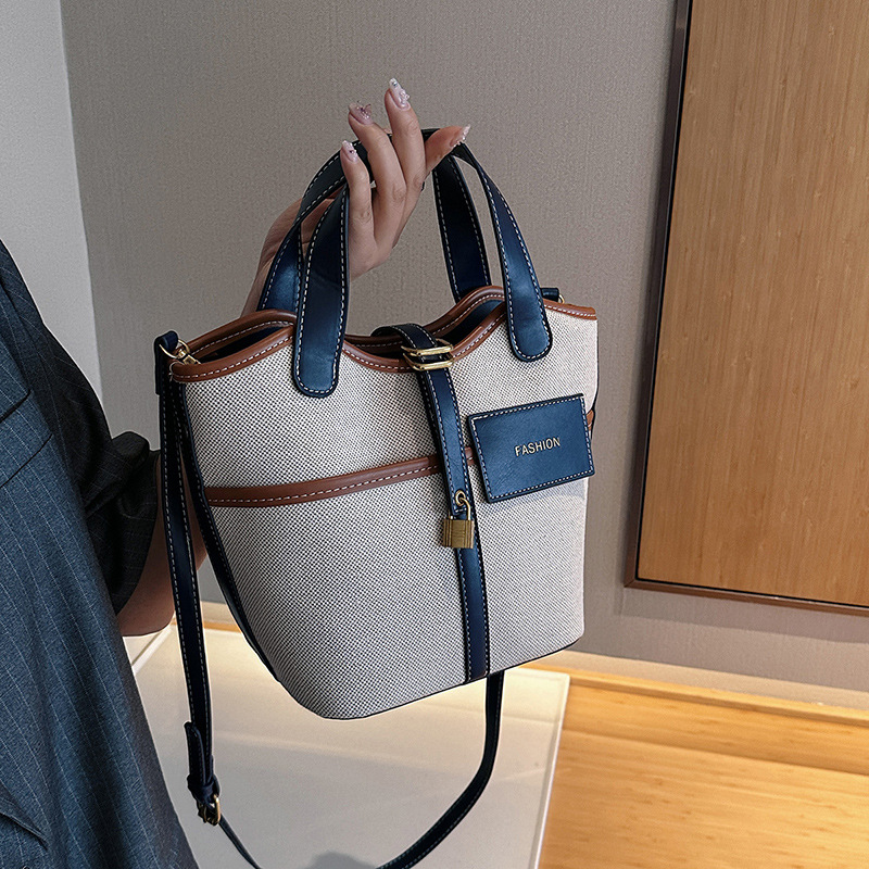 Nicho de diseño retrógrado lienzo portátil bolso de cubo de agua mujer 2026 nuevo cross-border ins canasta de moda bolso de mochila