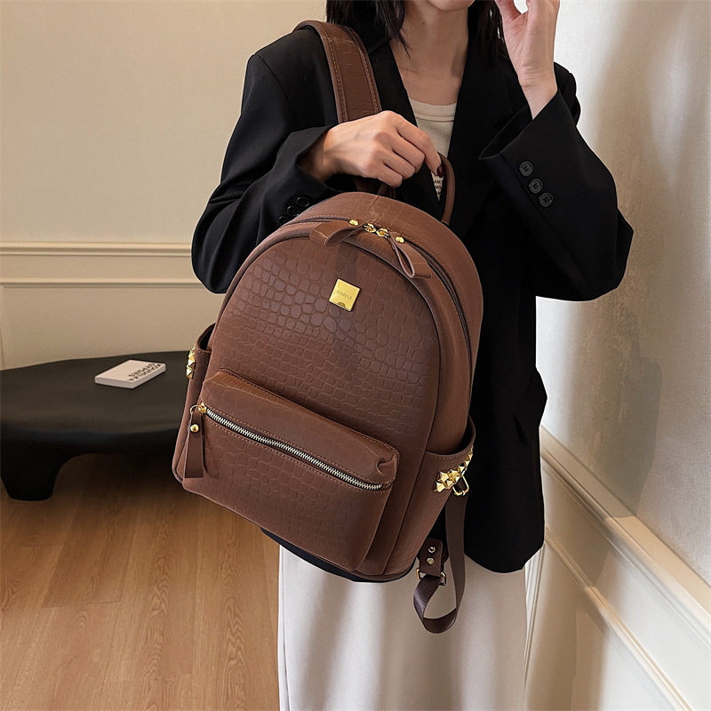 Mochila de viajes de gran capacidad de aire extranjero 2025 nueva mochila de mujer transfronteriza popular mochila de estudiantes universitarios con patrón de piedra