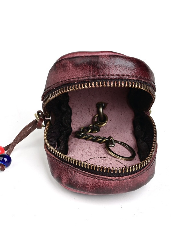 古潮客のレトロな頭の層の牛革の自動車の鍵の包みの女性の腰は手を掛けてなめの本革の家庭用の鍵の包みを植えます。