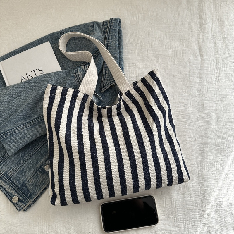 The new cross-border vertical striped commuter tote bag, hand-held shoulder bag, is fashionable and has a large capacity. It features an InS-style simple letter sail undefined
