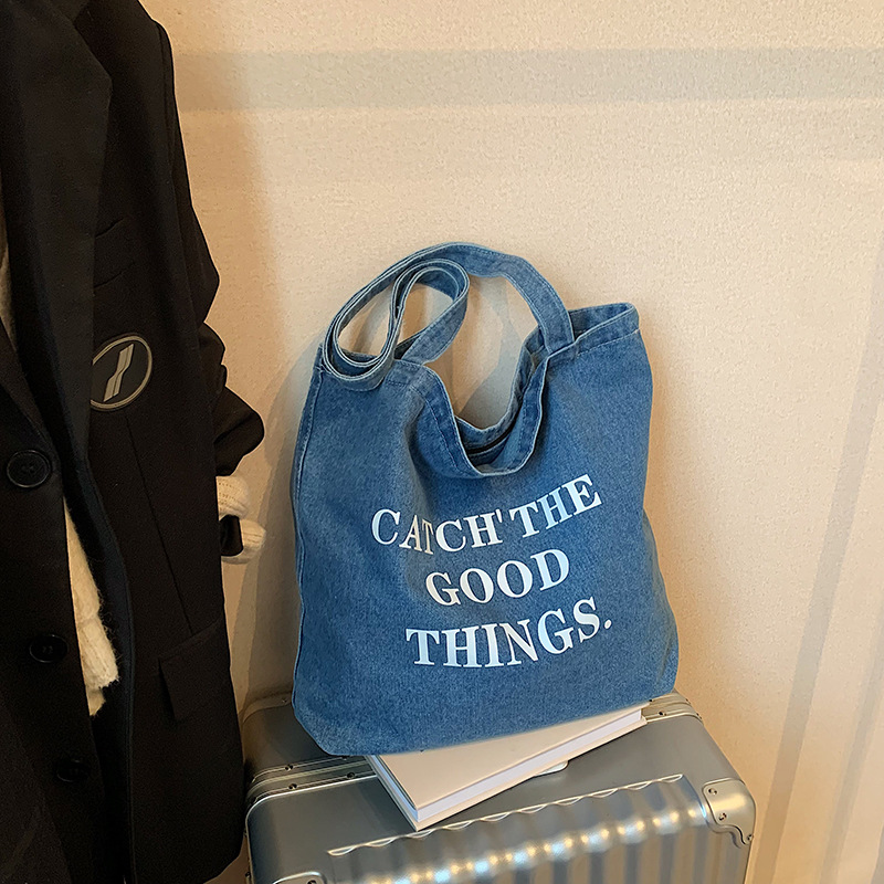 Bolsa de vaquín casual americana para estudiantes universitarios de clase viaje de compras letras de viento perezoso portátil gran capacidad bolso de hombro