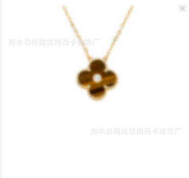Large four-leaf clover necklace in gold with tiger eye stone and diamonds in the middle