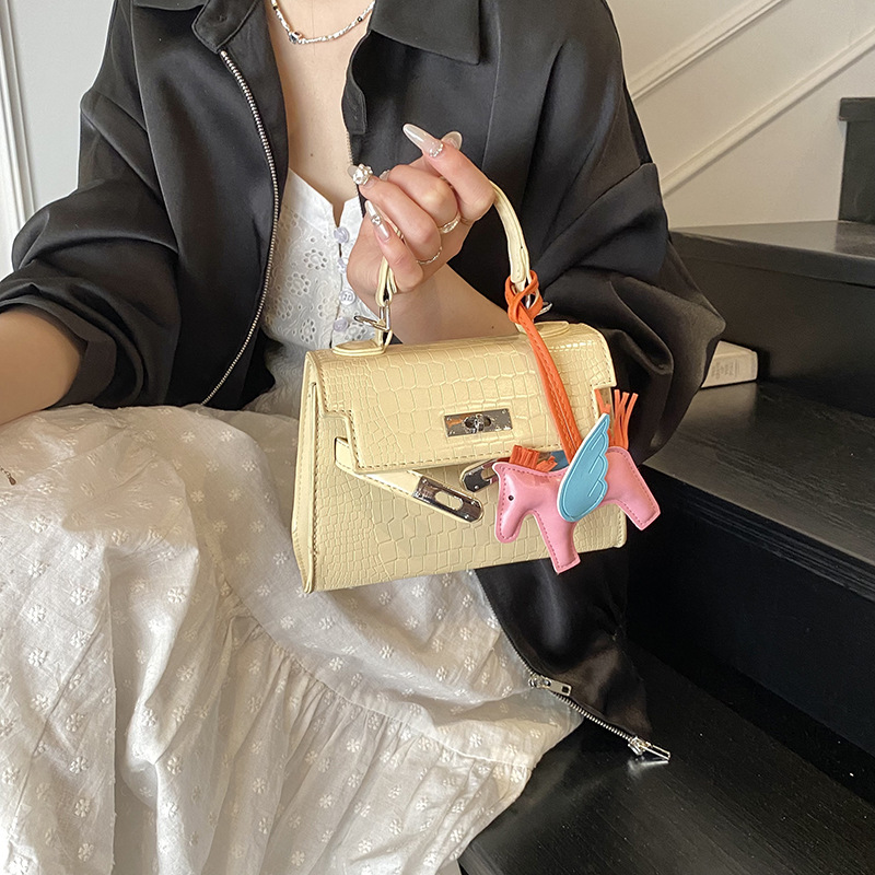 Bolso Kelly de mano de alta gama para mujer 2025 nueva moda casual bolso de hombro con patrón de piedra moda bolso de mensajero de color sólido