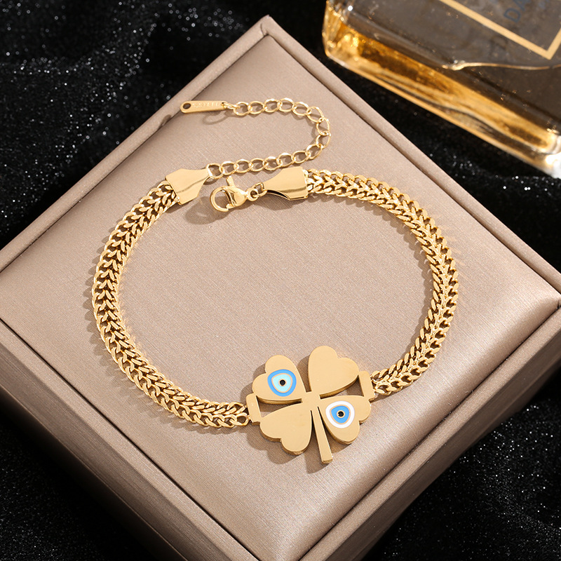 Amazon venta al por mayor transfronteriza Europa y América de moda ojos azules cuatro hojas colgante pulseras de acero joyas al por mayor