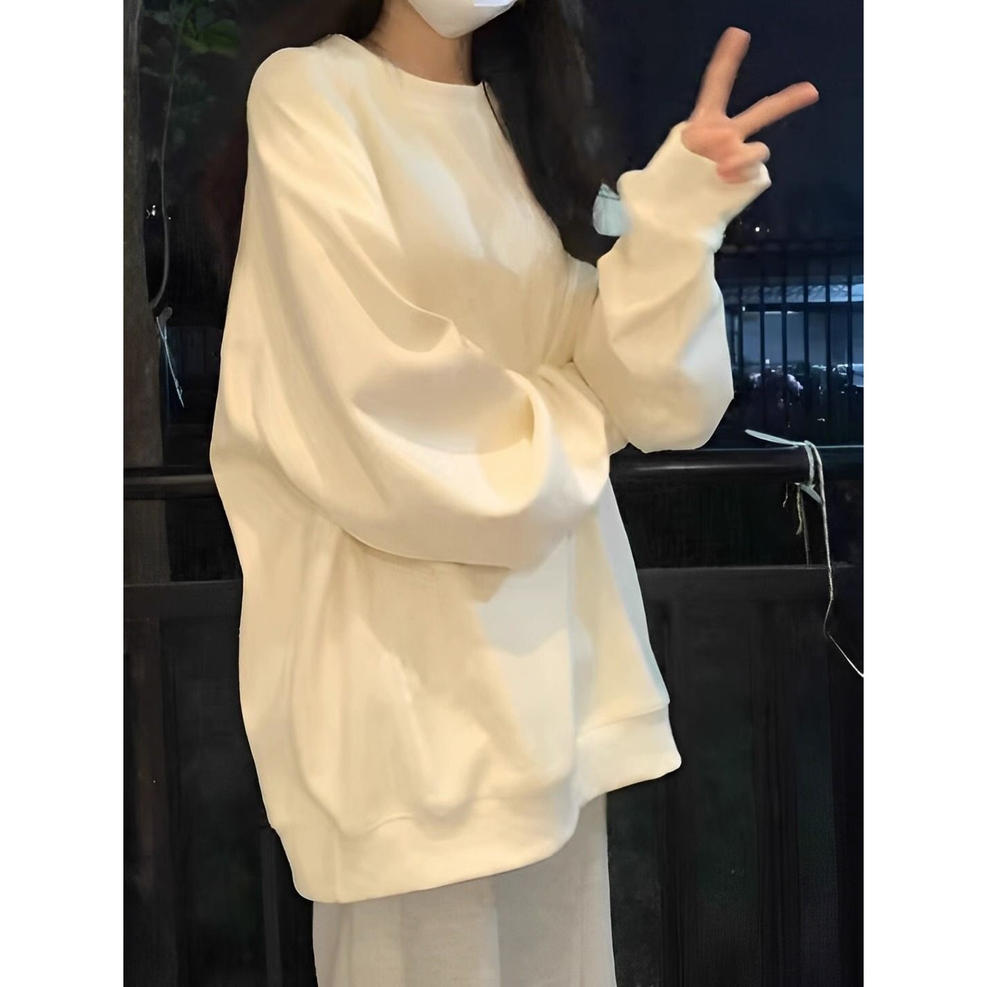 Trendy solid-color, hoodless, fleece-lined, and thick sweatshirt for autumn and winter, featuring a relaxed and stylish design, perfect for students, in an apricot color