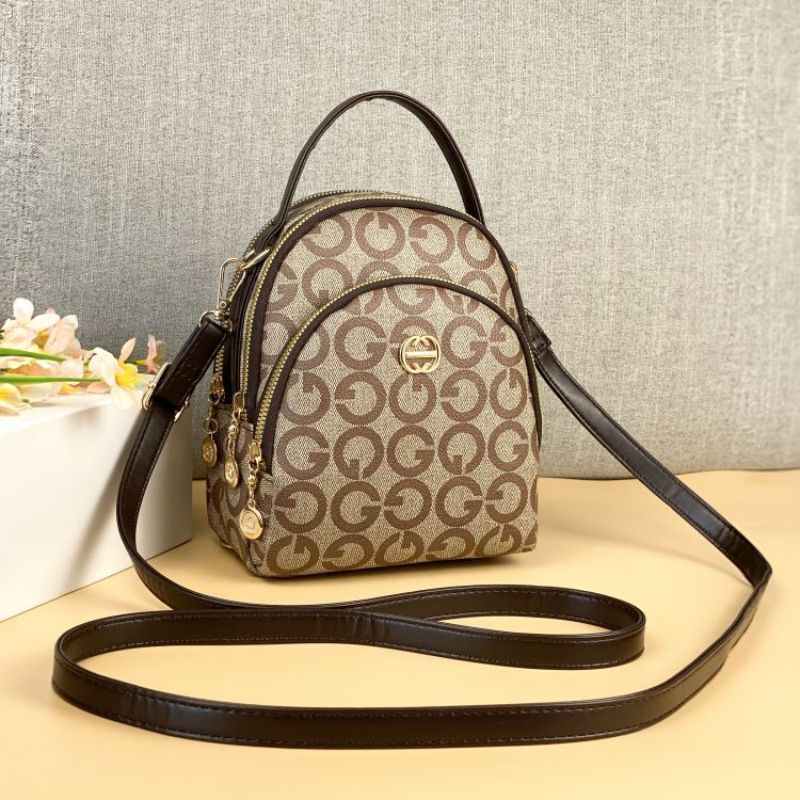 Guangzhou Hengli 2024 nueva moda mochila pequeña bolso de mano bolso de teléfono móvil madre de mediana edad bolso de mensajero de tres usar