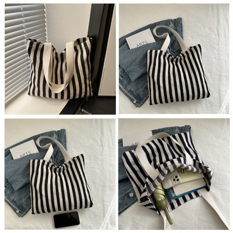 The new cross-border vertical striped commuter tote bag, hand-held shoulder bag, is fashionable and has a large capacity. It features an InS-style simple letter sail undefined