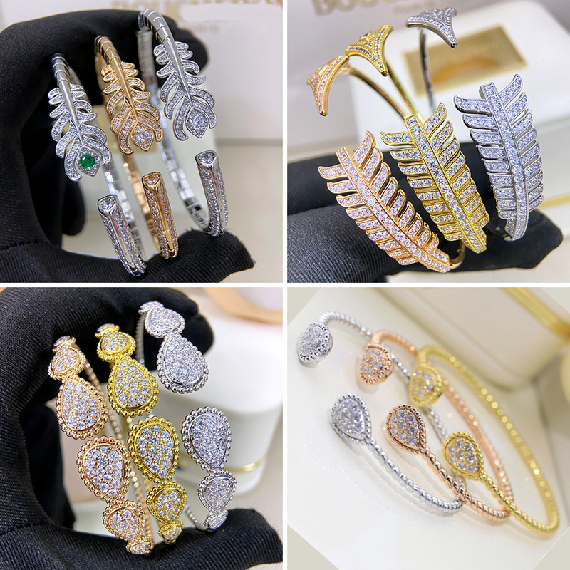 Teardrop-shaped bracelet made of 925 sterling silver plated with 18K gold, adorned with feathers and diamonds, elegant and stylish with a sweet and cool vibe Teardrop-shaped bracelet made of 925 sterling silver plated with 18K gold, adorned with feathers and diamonds, elegant and stylish with a sweet and cool vibe