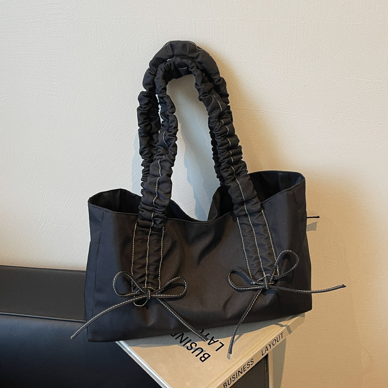 Bolso de arco de la mujer 2025 nueva moda coreana bolso de tela de gran capacidad bolso de mujer de alto valor facial