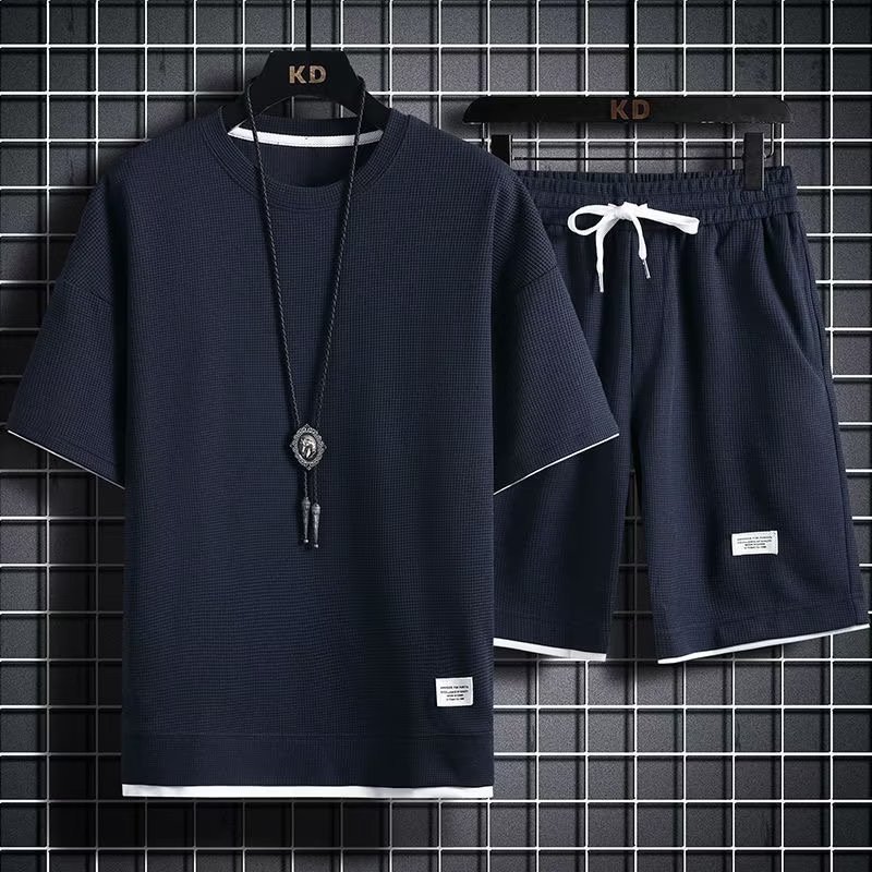 FUENTE fabricante waffle deportes ocio traje de los hombres en stock al por mayor estilo de Hong Kong suelta falso de dos piezas pantalones cortos de manga corta