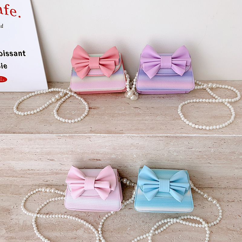 2026 nuevo bolso infantil lindos arco princesa bolso de perlas de color gradiente mini mochila