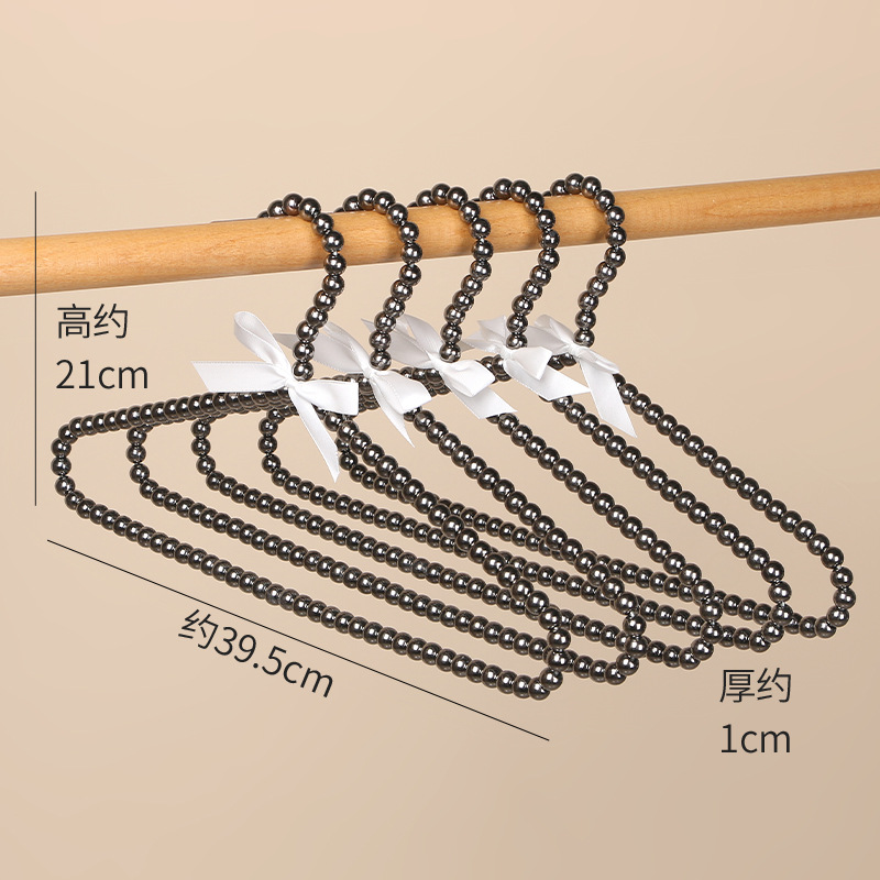 Tienda de ropa de mujer perla lujo ligero vestido retro arco adulto percha de ropa infantil estilo europeo hadas soporte de abrigo