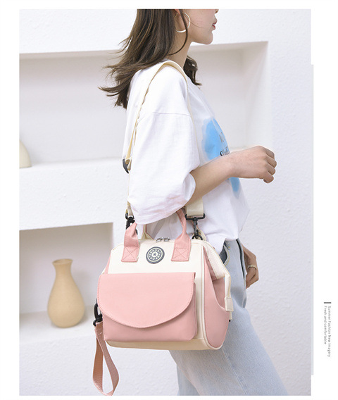 The Mommy bag is small and cute. It has a detachable front pocket and is a multi-functional baby bag. It is waterproof, lightweight, and has a crossbody design. It can be used to carry milk bags undefined