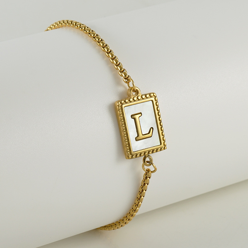 Nuevo europeo y americano transfronterizo de acero inoxidable 26 letras inglesas Shell pulsera personalidad todo partido titanio acero 18K cremallera