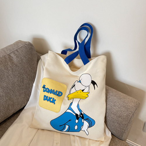 Original niche canvas bag for women, new cartoon Donald Duck hand-held tote bag for college students, reading single-shoulder cross-border