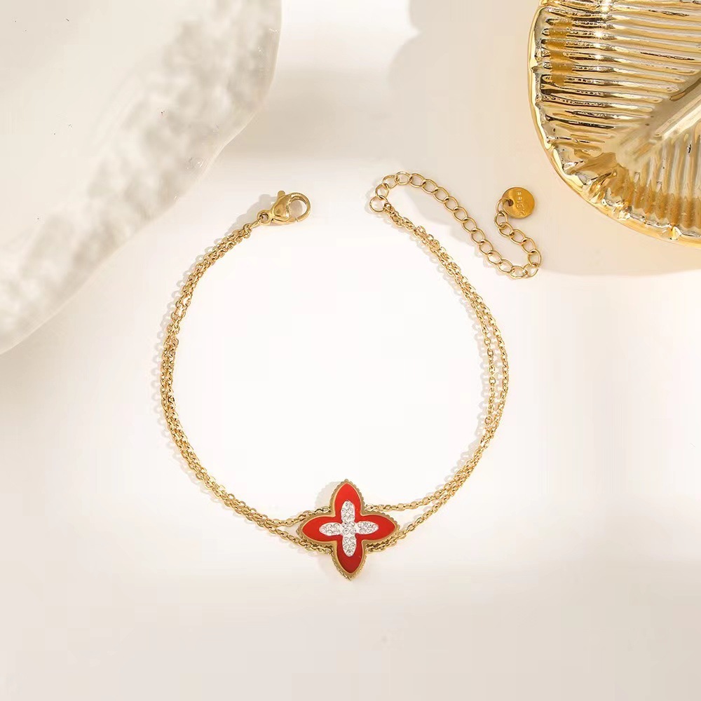 Pulsera de trébol de acero titanium vendedora caliente transfronteriza europea y americana con incrustaciones de concha pulsera colgante pulsera de diseño avanzado sin desvanecimiento al por mayor