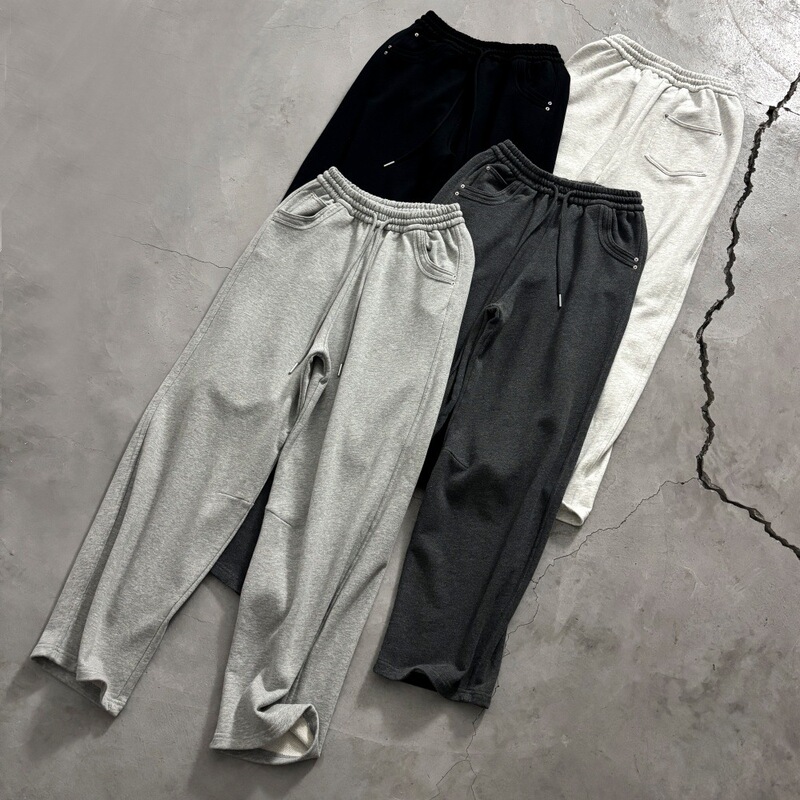 Designer-style Korean drawstring sweatpants with vertical side stripes, rivet pockets, loose fit, straight-leg cut, and casual terry fabric Designer-style Korean drawstring sweatpants with vertical side stripes, rivet pockets, loose fit, straight-leg cut, and casual terry fabric