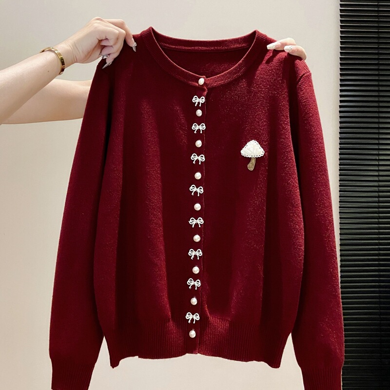 Stylish pearl-buttoned knitted cardigan for women, featuring a round neckline, mushroom embroidery, a bow detail, and long sleeves, perfect for early autumn wear Stylish pearl-buttoned knitted cardigan for women, featuring a round neckline, mushroom embroidery, a bow detail, and long sleeves, perfect for early autumn wear