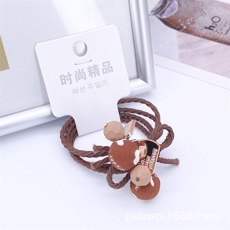 Otoño e invierno té de leche color paño bola cuerda del pelo 2 tarjetas leopardo cabeza cuerda simple hilo colgando bola banda de goma 2 yuanes tienda de suministro