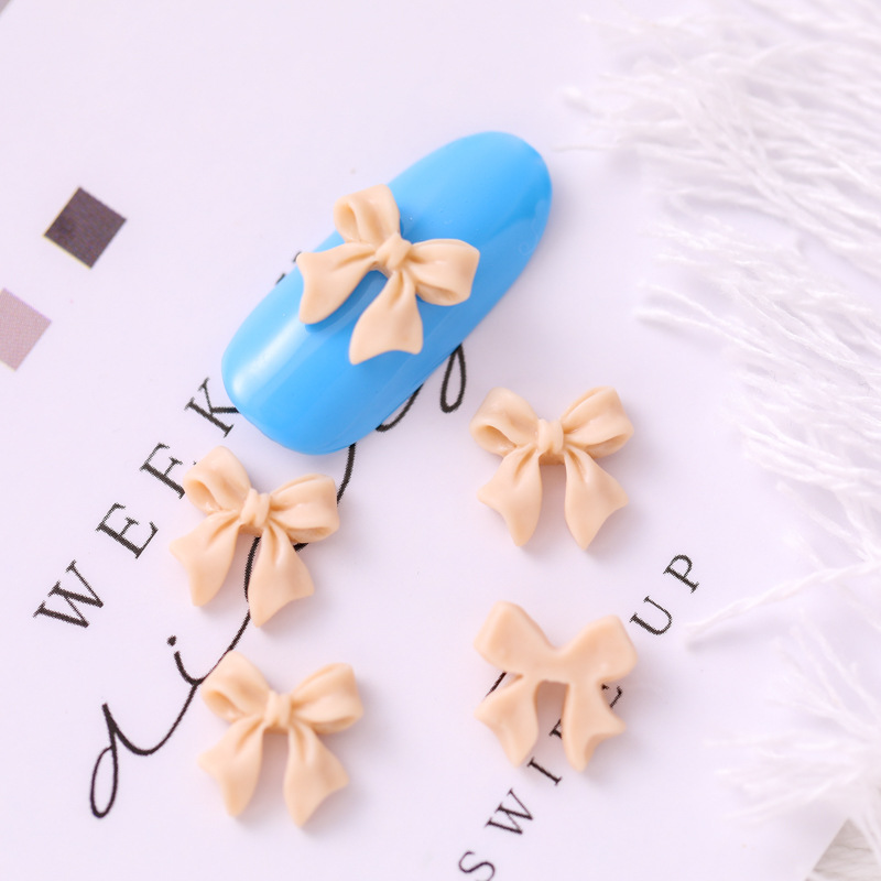 Mariposa de uñas popular repujado arco resina pajarita joyería simple todo partido tridimensional hueco decorativo diamante