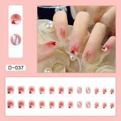Heart-shaped blushing nail art with Aurora Borealis rhinestones, detachable nail stickers, and decorative nail pieces