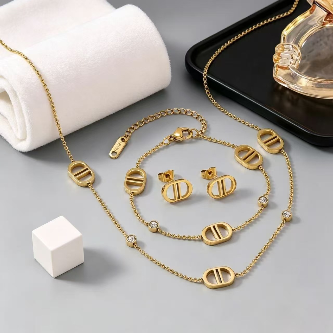 Fashionable stainless steel double D jewelry three-piece set: necklace, bracelet, and earrings set for women, available for wholesale