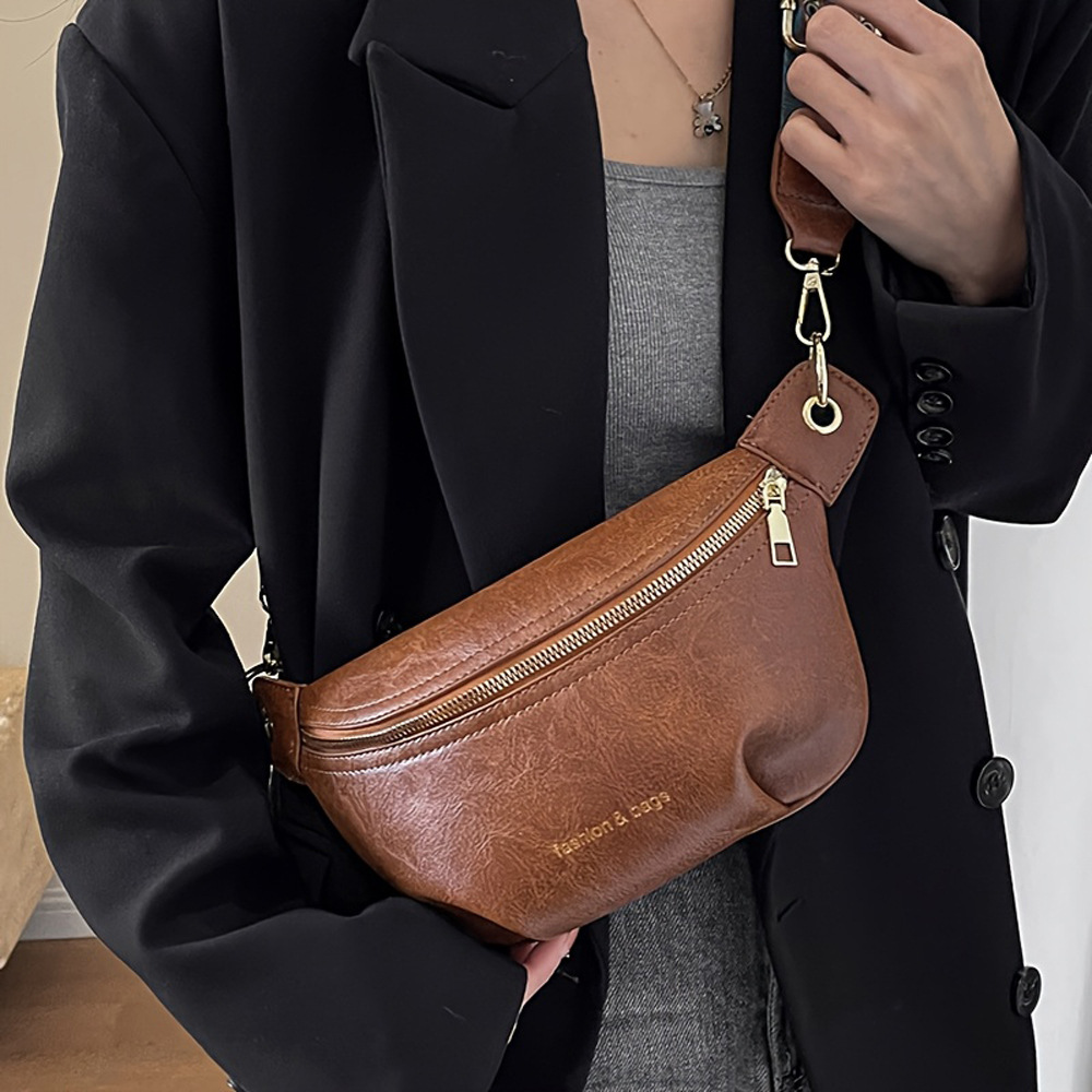 Bolso de diseño de nicho para mujeres versátil 2025, nuevo bolso de hombro de banda ancha para mujeres, bolso de pecho, bolso de cintura.