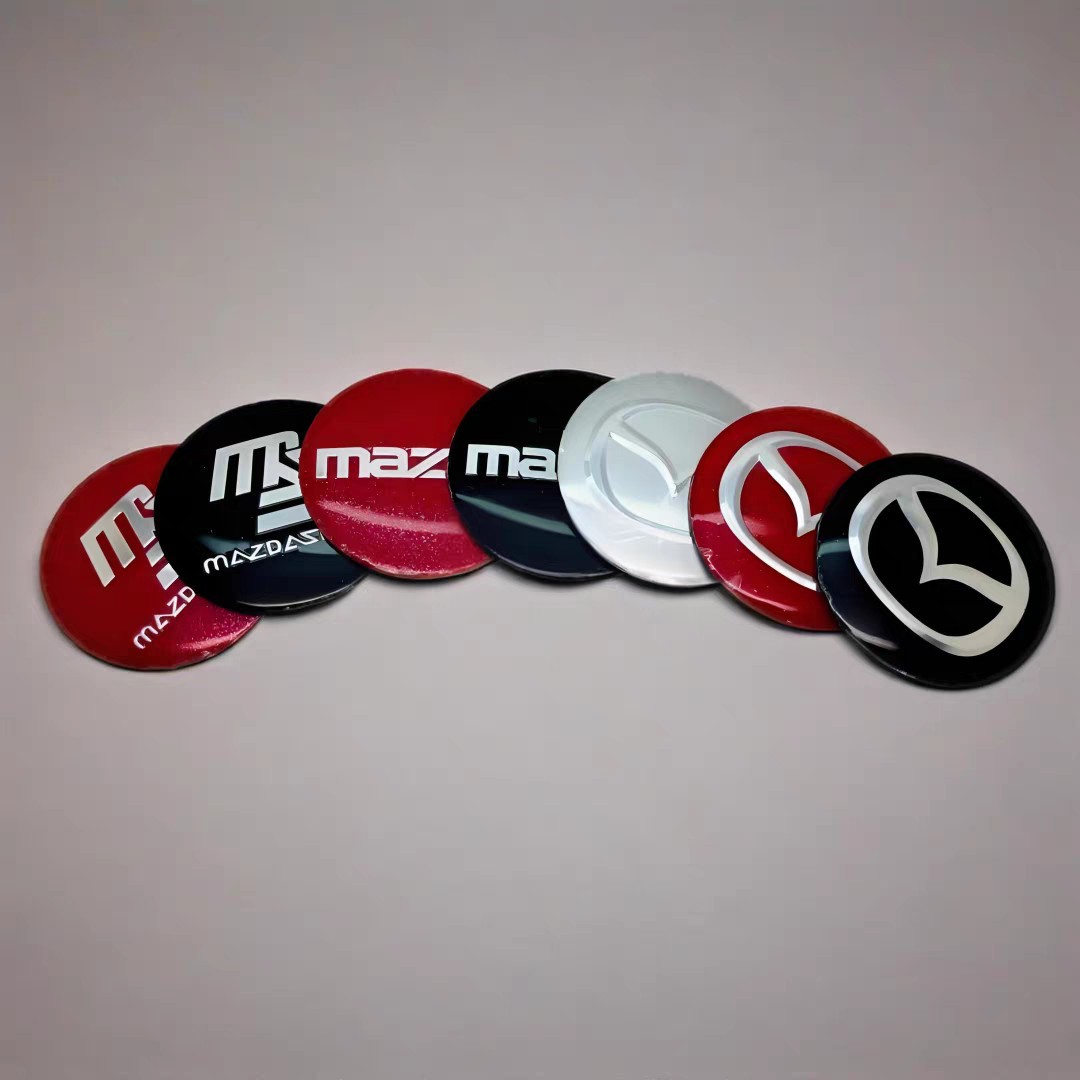 Mazda modifikatsiyalari, jumladan, shaxsiylashtirilgan logotipli, 56 mm bo'lgan Axela, CX50, Mazda3, Mazda6 va Xingcheng shinalari markaziy qopqoqlari uchun mos keladi.
