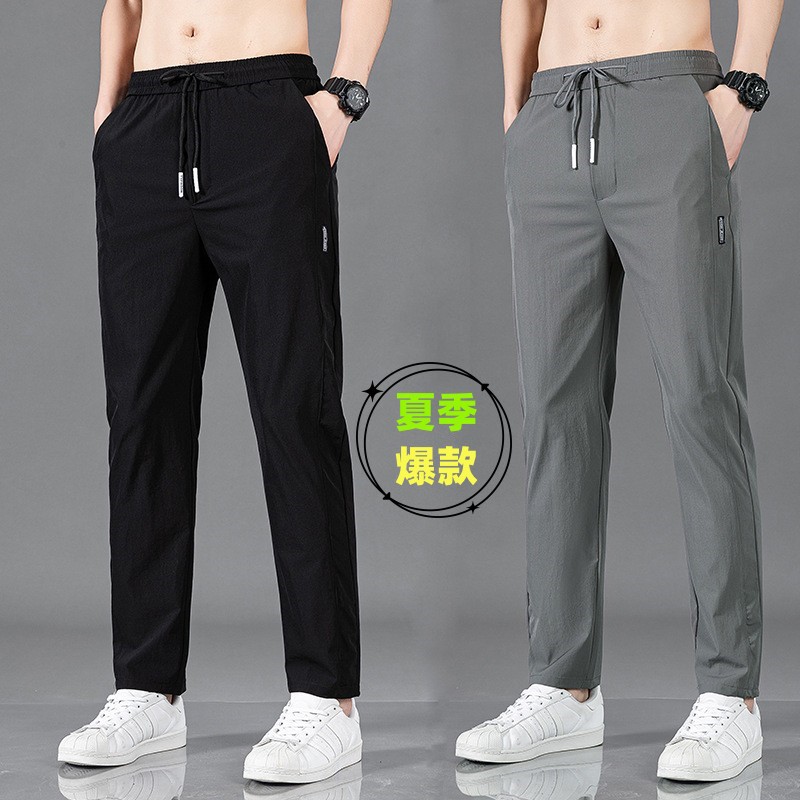 Pantalones largos delgados de verano para hombres tendencia universal de hielo rápido secado deportivo relajado grande pantalones casuales al por mayor