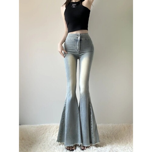 Plus-size flared denim jeans for women, high-waisted, wide-leg design—perfect for an early autumn look that slims and highlights a retro vibe with stretchy, floor-length fabric.