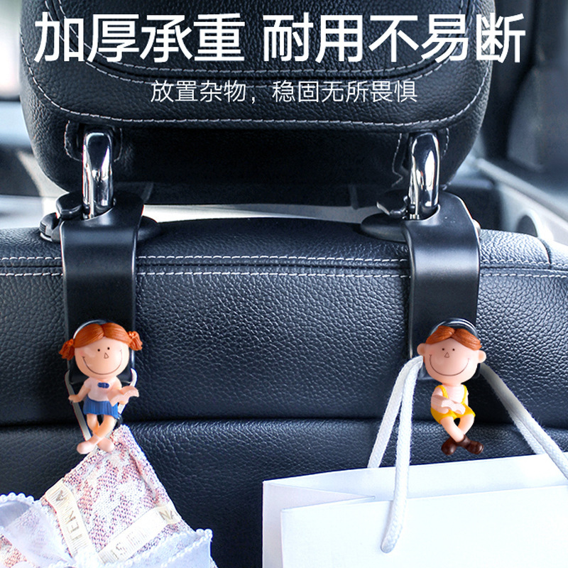 Accesorios interiores de automóviles transfronterizos gancho trasero gancho de asiento de automóvil pareja encantadora lectura de dibujos animados muñeca popularidad en línea