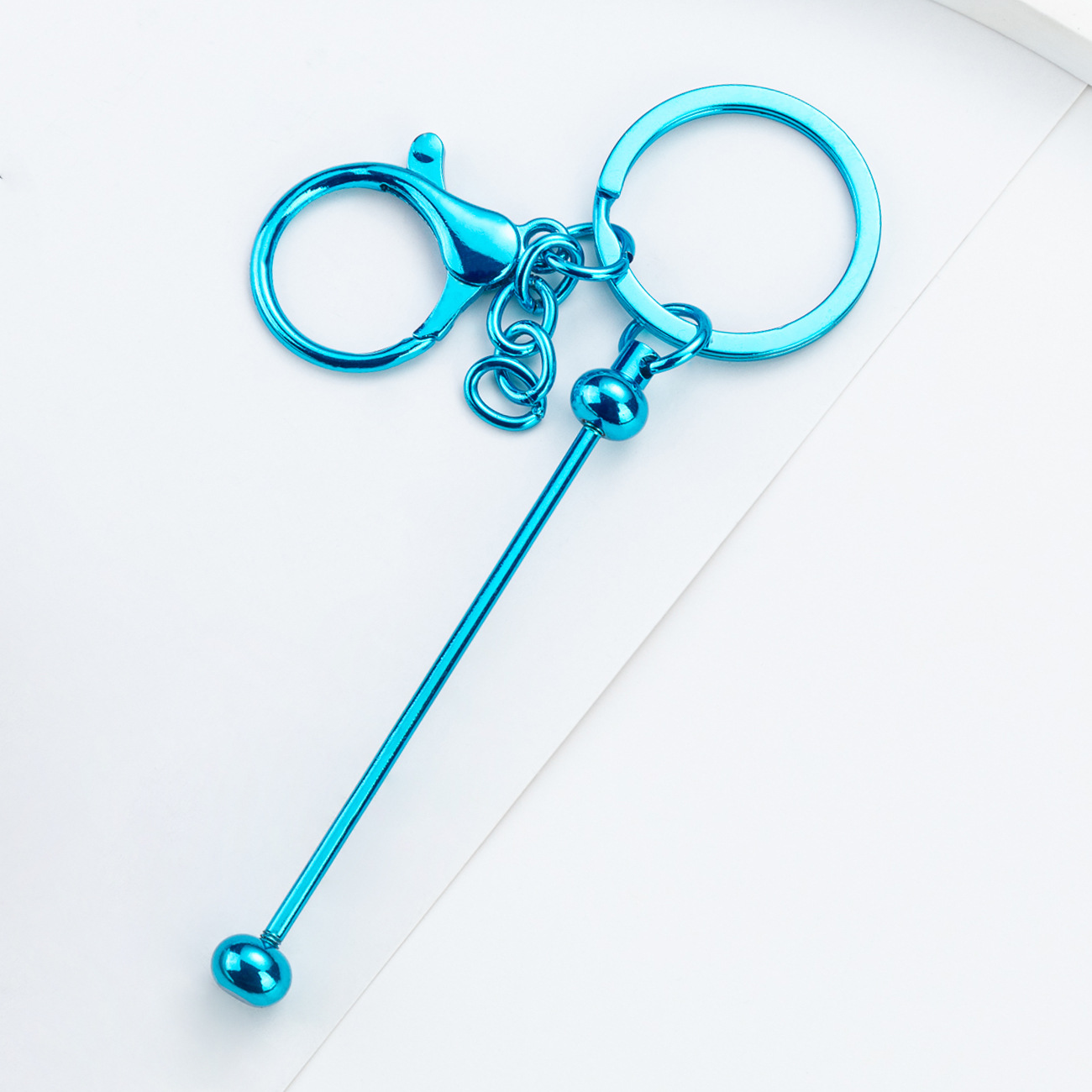 DIY cuentas llaveros auriculares caja de teléfono celular colgante llaveros de metal chapeado UV llaveros al por mayor spot