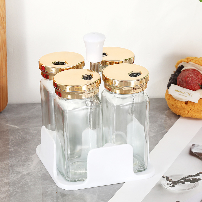 Botella cuadrada de lujo ligera de cuatro piezas Botella de condimento de vidrio de cocina Olla de aceite Tanque de sal a prueba de humedad Tarro de condimento Botella giratoria