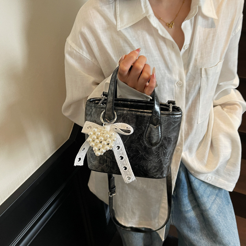 Bolso Tote popular de este año 2025 verano nuevo bolso bolso de hombro con patrón de agarre lindo bolso de mensajero de todo fósforo mujer