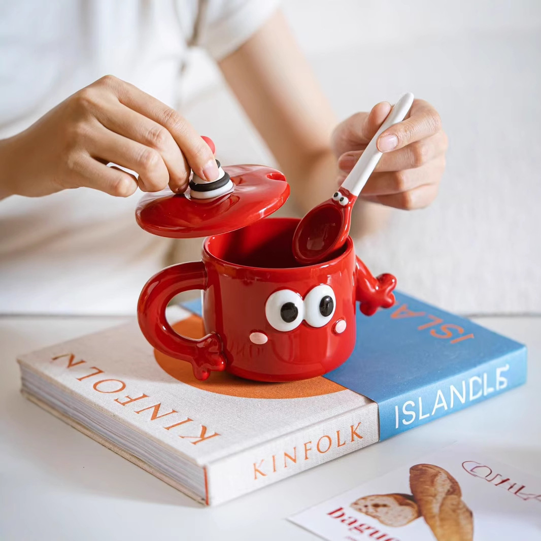 Personalidad de dibujos animados adorables ojos grandes negros y rojos copas de agua de cerámica encantadora mano a mano taza con cubierta taza de café cuchara