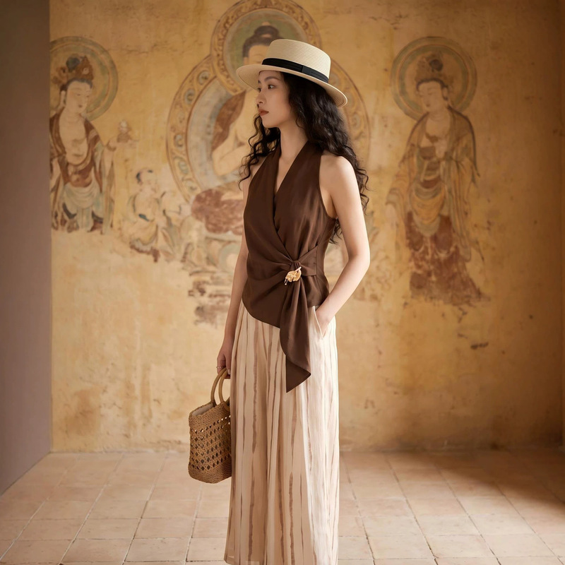 Elegantly crafted French retro-style asymmetrical sleeveless top and wide-leg pants, a chic two-piece set for women with a sophisticated and mature look