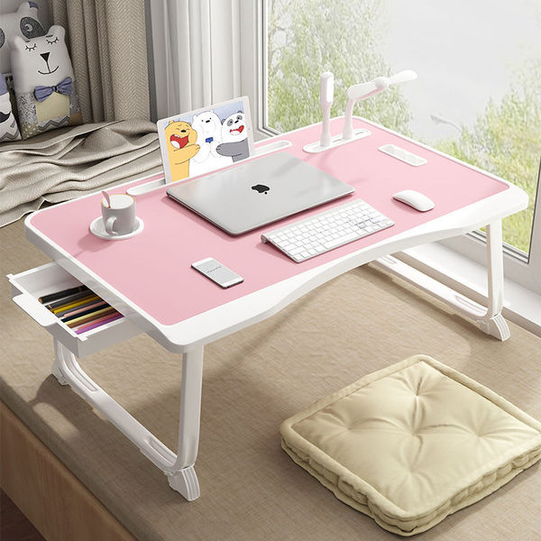 Folding the mobile lifting laptop computer table beside bed