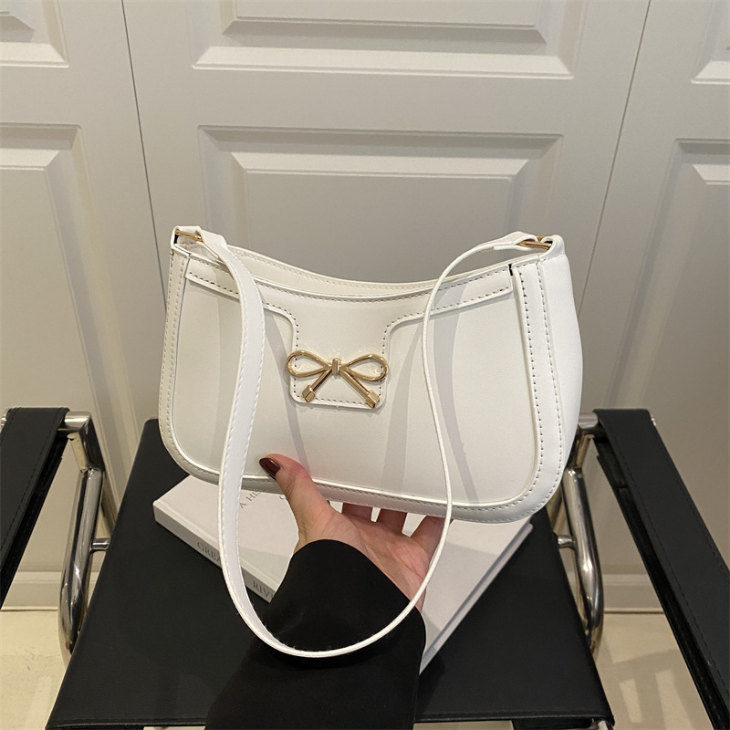 Bolso de hombro popular de este año con lazo para damas de gran capacidad 2025 color sólido nuevo bolso de axila simple de textura de moda