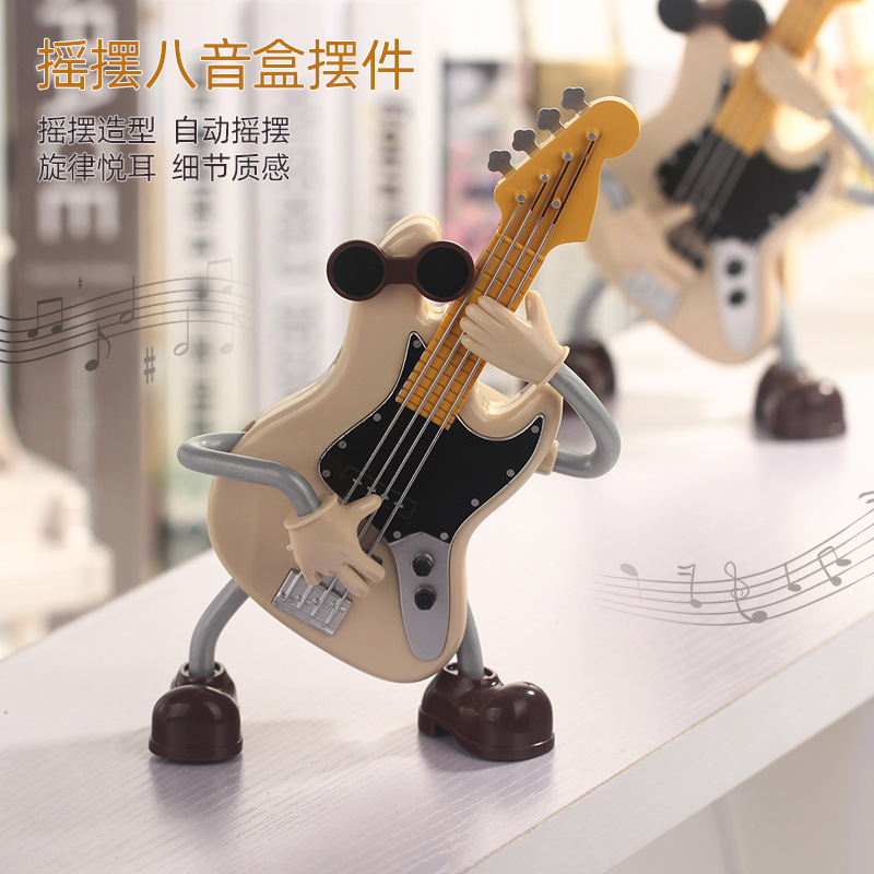 Creativo nueva guitarra muñeca caja de música oscilación automática decoración de escritorio caja de música de dibujos animados regalo de vacaciones al por mayor