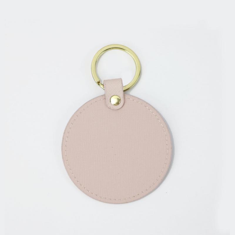 Llavero redondo de cuero genuino personalizado creativo simple colgante hombres y mujeres pequeño exquisito pequeño regalo al por mayor todo a juego