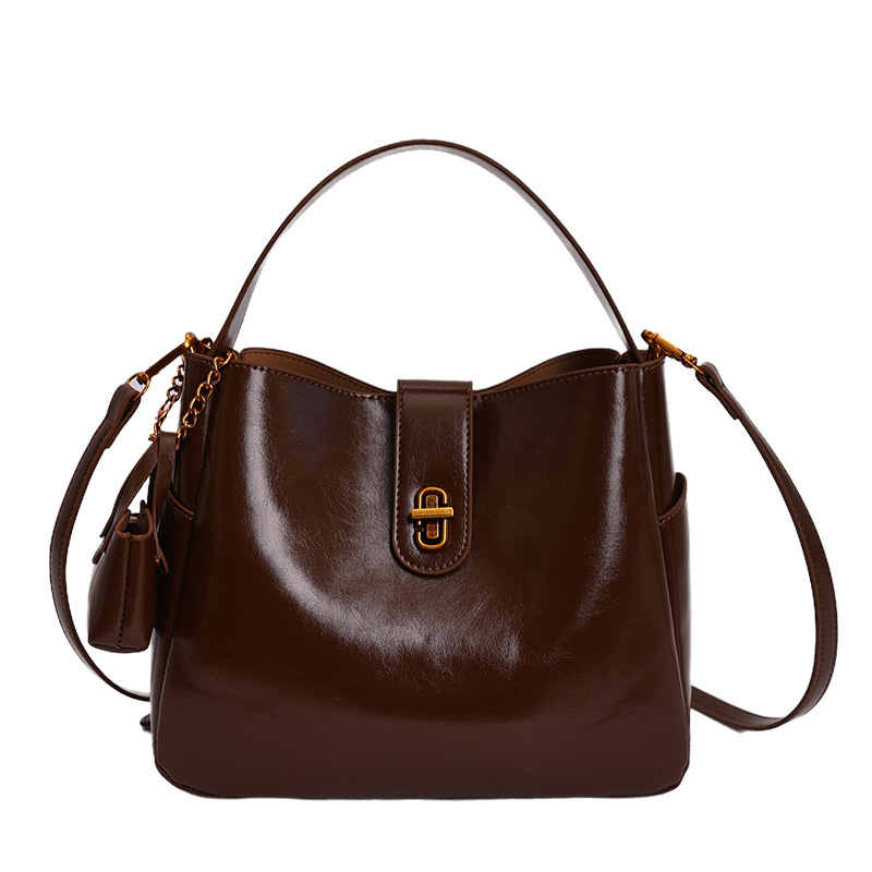 Bolsa portátil de cuero de cera retrógrada para mujeres 2026 nueva sensación de lujo ligera de alta calidad de moda versátil mochila de hombro