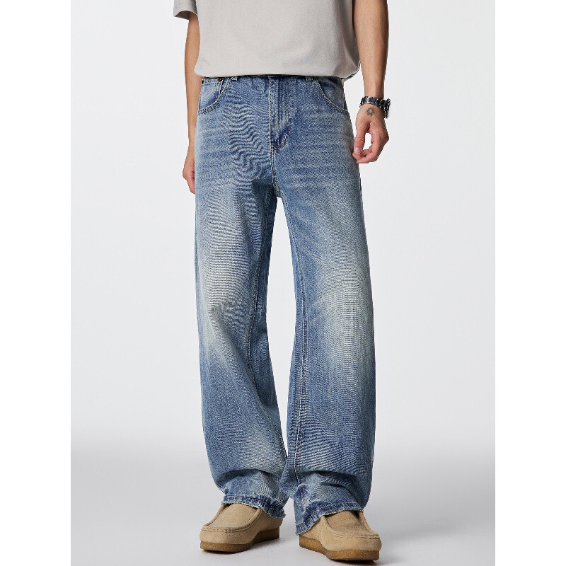 GTRG vintage light blue cleanfit slightly distressed long pants with a vintage wash, whiskering, and tie-dye design