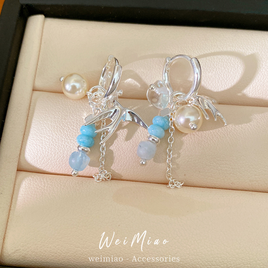 Accesorios de vacaciones golondrina perlas perlas auriculares temperamento nicho de moda aretes ligeros de lujo alta sensación auriculares al por mayor
